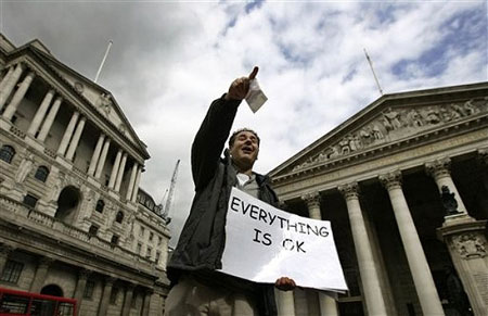 Ahead of the G20 summit, a lone protester delivers a speech on the financial issues, back dropped by the Bank of England, left, and the Royal Exchange, right, in central London's City financial district, Tuesday March 31, 2009. 